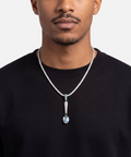 Blue topaz spoon pendant worn on a diamond tennis chain