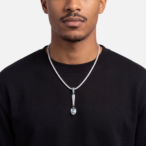 Blue topaz spoon pendant worn on a diamond tennis chain