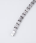 Reverse of the diamond butterfly bracelet showing open back settings and engraved clasp