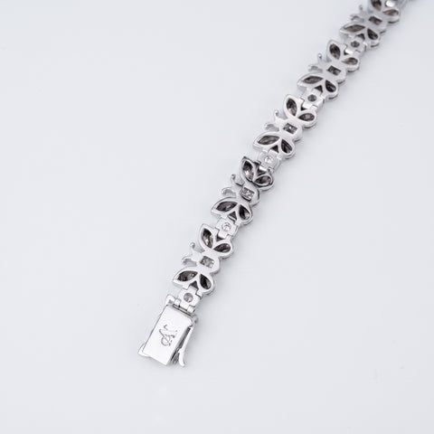 Reverse of the diamond butterfly bracelet showing open back settings and engraved clasp