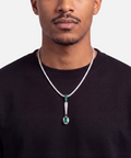 Emerald spoon pendant worn on a diamond tennis chain