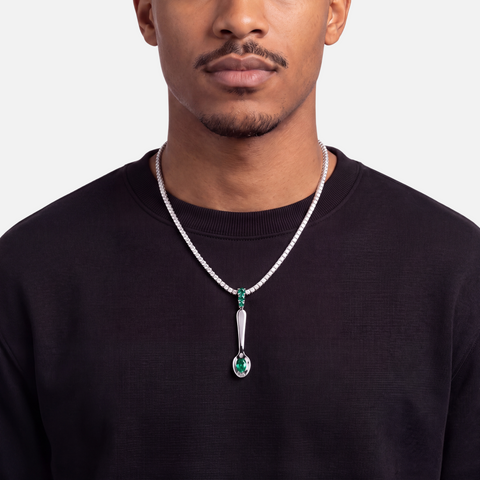 Emerald spoon pendant worn on a diamond tennis chain