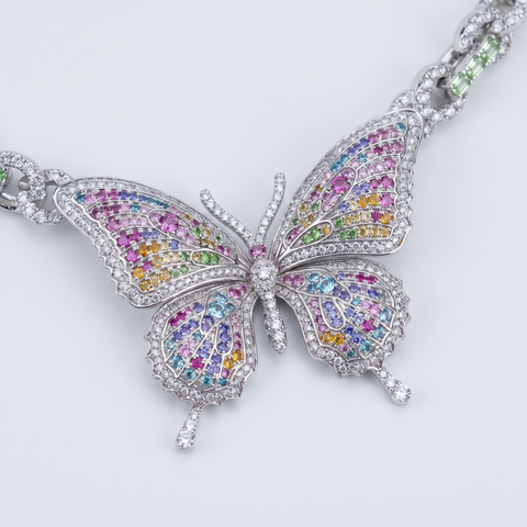 Butterfly pendant angled close up with diamonds and fancy coloured gemstones
